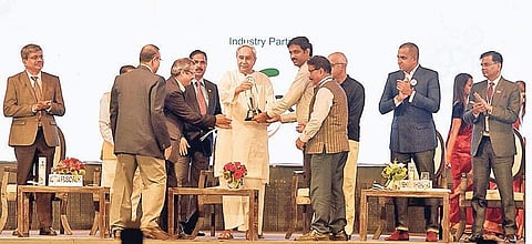 Chief Minister Naveen Patnaik felicitating OMC officials for the Best CSR award at Make In Odisha Conclave in Bhubaneswar on Tuesday (Photo: ENS)