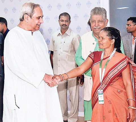 Chief Minister Naveen Patnaik congratulates SHG leader Jayanti Ekka after her speech during Make in Odisha Conclave on Wednesday | express
