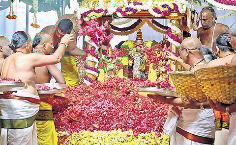 Priests offering flowers to the deity of Lord Malayappa Swamy and His two consorts during Pushpa Yagam performed at Tirumala temple on Wednesday | Express