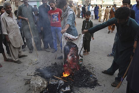 Pakistani protesters burn a poster image of Christian woman Aasia Bibi, in Hyderabad, Pakistan. (Photo | AP)