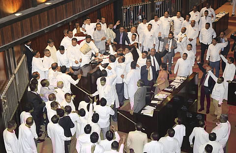 A trash can is thrown towards speaker Karu Jayasuriya, seated and partly visible, by Sri Lankan lawmakers supporting disputed Prime Minister Mahinda Rajapaksa at the parliament chamber in Colombo, Sri Lanka, Thursday, Nov. 15, 2018. (Photo | AP)