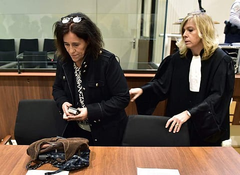 Rosa Maria Da Cruz (L) arrives with her lawyer Chrystele Chassagne-Delpech (R) for the first day of her trial before the Assize Court of Tulle, central France on November 12, 2018, for having kept her daughter Serena in the trunk of a car during the child