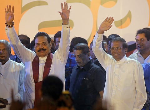 Sri Lankan president Maithripala Sirisena, right, and his newly appointed prime minister Mahinda Rajapaksa wave to supporters during a rally held out side the parliamentary complex in Colombo, Sri Lanka, Monday, Nov. 5, 2018. (Photo | AP)