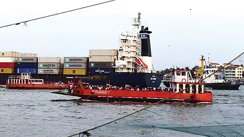 A container ship moving along the shipping channel at the Cochin Port.