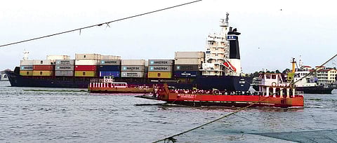 A container ship moving along the shipping channel at the Cochin Port.