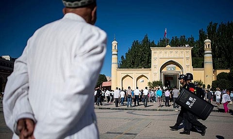 File photo of men arriving at a Mosque for the morning prayer in China's Xinjiang Uighur Autonomous Region. (Photo| AFP)