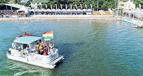 Chief Minister N Chandrababu Naidu carrying national flag during F1H2O event in Vijayawada on Sunday; (Below)winners celebrate after the event I Express