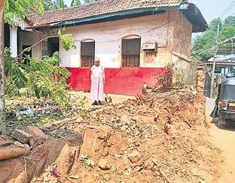 Lakshmidevi Pai in front of her house
