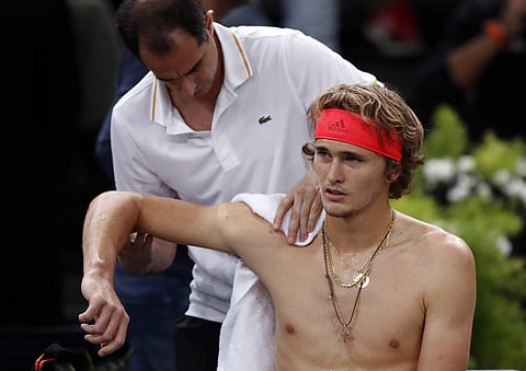 Alexander Zverev of Germany receives medical attention during his quarter-final match against Russia's Karen Khachanov at the Paris Masters | AP