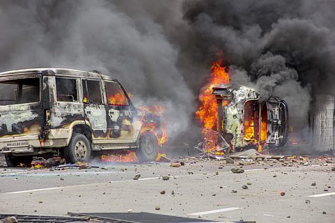 Flames rise from a burning vehicle as Maratha Kranti Morcha protesters clashed with police personnel during a protest called for reservations in jobs and education in Navi Mumbai on July 25 2018. (File photo | PTI)