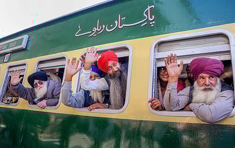 Attari Sikh pilgrims wave from a special train as they leave for Pakistan from Attari Railway Station (Photo| PTI)
