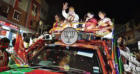 State BJP president K Laxman waves to the public during his election campaign at Ram Nagar, in Hyderabad on Wednesday | S senbagapandiyan