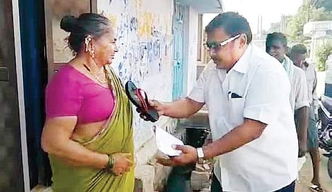 An Independent candidate A Hanumanlu giving footwear and resignation letter to voters in Korutla in Jagtial district on Thursday | Express
