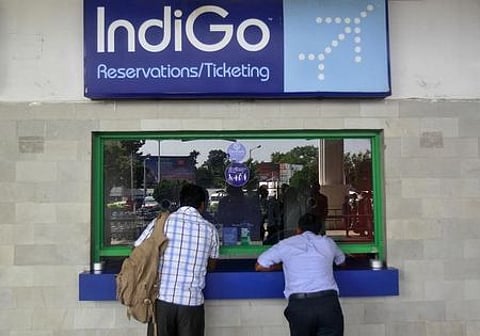 Passengers stand at the ticket counter of Indigo Airlines at the airport on the outskirts of Agartala ( File photo| Reuters )