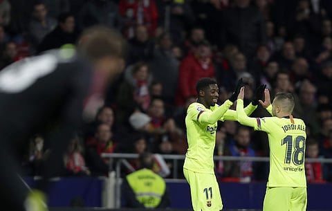 Barcelona's Ousmane Dembele, center, celebrates with Jordi Alba after scoring his side's opening goal during a Spanish La Liga soccer match between Atletico Madrid and FC Barcelona on November 24, 2018. (Photo | AP)