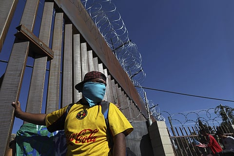 Migrants gather at the Mexico-U.S. border after getting past a line of Mexican police at the Chaparral crossing in Tijuana, Mexico, Sunday, Nov. 25, 2018, as they try to reach the U.S. (Photo | AP)