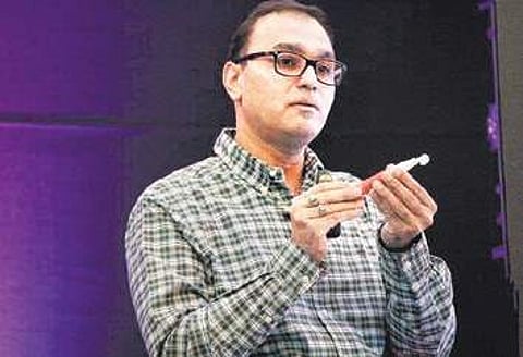 Dr Vijay Rao shows his AUM voice prosthesis device