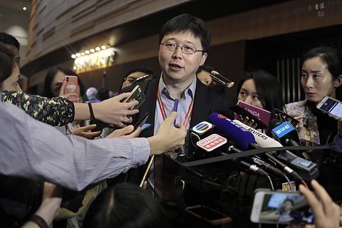 Feng Zhang, center, an institute member of Harvard and MIT's Broad Institute, reacts to reporters on the issue of world's first genetically edited babies after the Human Genome Editing Conference in Hong Kong, Tuesday, Nov. 27, 2018. (Photo | AP)