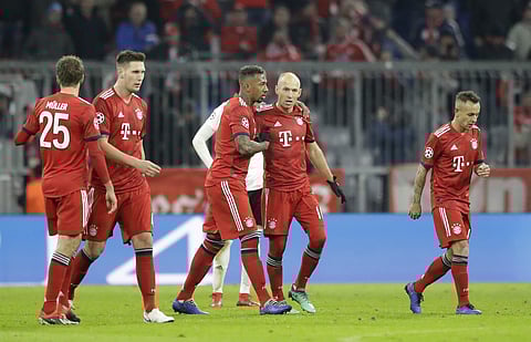 Bayern Munich midfielder Arjen Robben is congratulated by his teammates after scoring their second goal during the Champions League group E match against Benfica Lisbon in Munich | AP