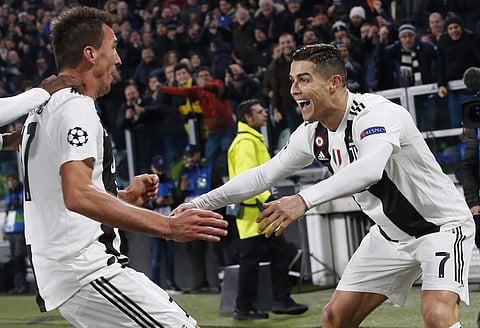 Juventus forward Mario Mandzukic (L)celebrates with his teammate Cristiano Ronaldo after scoring during the Champions League group H match against Valencia at the Allianz stadium in Turin | AP