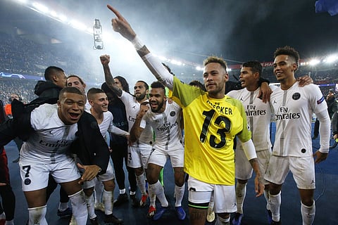 PSG players celebrate their victory, with Neymar wraring Liverpool goalkeeper Alisson' yellow jersey, after the Champions League Group C second leg match | AP