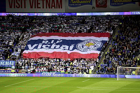 Leicester City fans with a giant banner that reads 'RIP Vichai' during the English Premier League soccer match between Cardiff City and Leicester City at the Cardiff City Stadium, Cardiff | AP