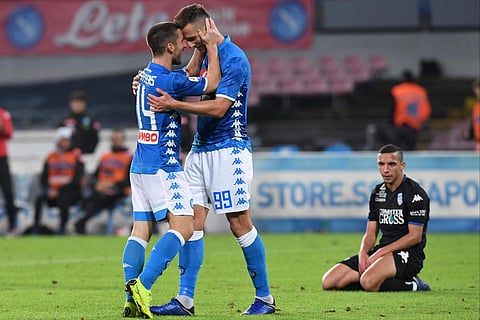 Napoli's forward Arkadiusz Milik, right, celebrates with his teammate Dries Mertens after scoring his side's fourth goal during the Italian Serie A soccer match between Napoli and Empoli at the San Paolo stadium in Naples, Italy, Friday, Nov. 2, 2018. | A