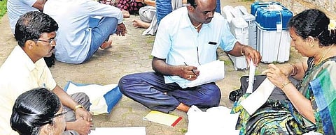 Election staff check documents and electronic voting machines (EVMs) in Mandya on Friday. The bypoll to Mandya Lok Sabha constituency will be held on Saturday | EXPRESS
