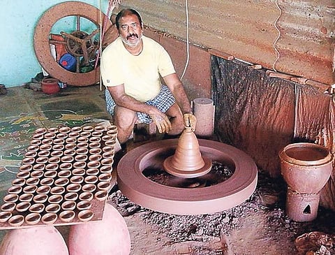 With Diwali approaching soon, a potter works tirelessly on his wheel at the congested lanes of Kummari Veedhi | EXPRESS