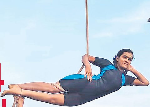 A student practises rope yoga.