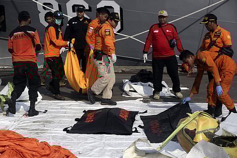 Rescuers carry body bags containing the remains of the victims of Lion Air crash at Tanjung Priok Port in Jakarta, Indonesia, Friday, Nov. 2, 2018. | AP