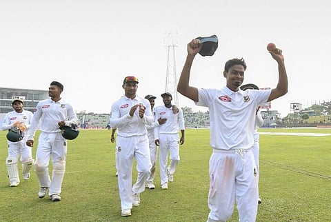 Bangladesh cricketer Taijul Islam (R) acknowledges the crowd as he gets 11 wickets during the third day of the first Test cricket match between Bangladesh and Zimbabwe in Sylhet on November 5, 2018. (Photo | AFP)