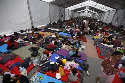 Central American migrants, part of a caravan hoping to reach the U.S. gets settled in a shelter at the Jesus Martinez stadium, in Mexico City. (Photo | AP)