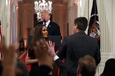 President Donald Trump watches as a White House aide takes away a microphone from CNN journalist Jim Acosta during a news conference in the East Room of the White House, Wednesday, Nov. 7, 2018 | AP