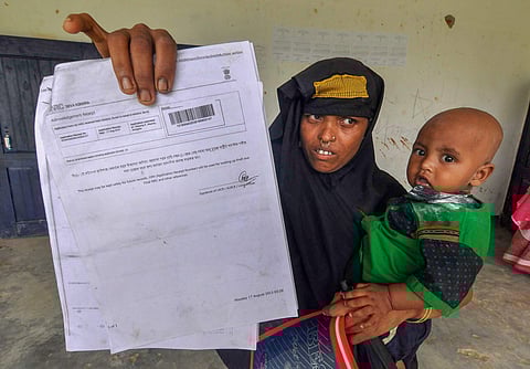 A woman shows an NRC acknowledgment receipt to check her name in the list of Assam's NRC in the state. (File Photo | PTI