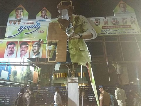 The Sarkar banner damaged by the AIADMK party workers in Tiruchy. | EPS