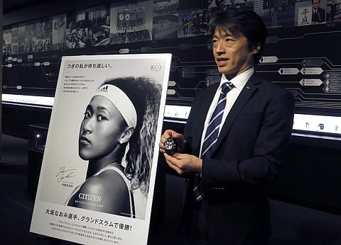 Shigeru Tanaka, advertising manager at Citizen, speaks while showing one of Naomi Osaka watches, which she wears during her tennis matches, at the company's headquarters in Tokyo | AP