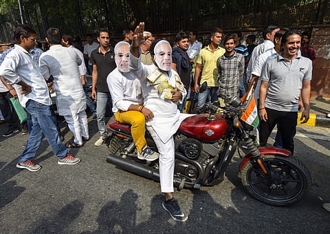 Indian Youth Congress (IYC) members wear Modi masks during a protest march on the 2nd anniversary of demonetisation outside RBI Headquarters in New Delhi Friday November 9 2018. | PTI