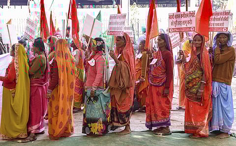 Farmers hold placards ahead of their march from Ramlila Maidan towards Parliament in New Delhi (Photo | PTI)