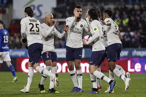 PSG's Edinson Cavani, with the ball, celebrates with teammate after scoring a goal during the League One soccer match between Strasbourg and Paris Saint Germain at the Stade de la Meinau stadium in Strasbourg, eastern France, Wednesday Dec.5, 2018. | AP