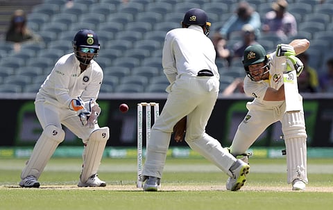 Australia's Tim Paine, right, watches the ball while batting on the final day of the first cricket test between Australia and India in Adelaide, Australia,Monday, Dec. 10, 2018. | AP