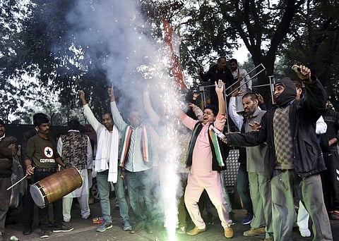 Congress Party workers celebrate as initial trends show the party leading in the states Assembly elections at Congress office in New Delhi (Photo | PTI)