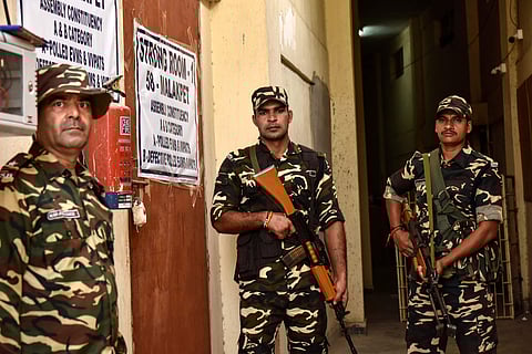 Security personnel stand guard at Amberpet GHMC grounds where sealed EVM's and VVPATS are stored (Photo | EPS/Vinay Madapu)