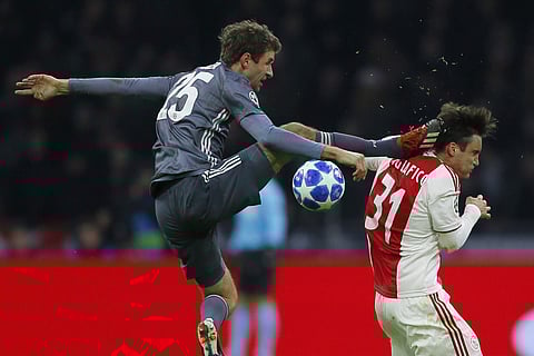 Ajax's Nicolas Tagliafico is fouled by Bayern Munich's Thomas Mueller during their Champions League group E match (Photo | AP)