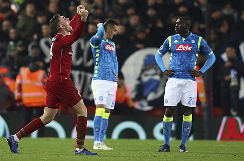 Liverpool midfielder Jordan Henderson (L) celebrates after his team won the Champions League Group C match against Napoli (Photo | AFP)
