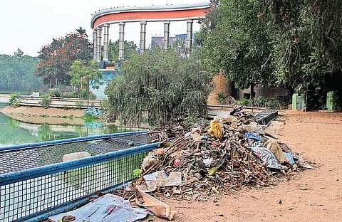 Foul stench from the garbage scooped out of the lake in Jalgam Vengal Rao park — that has been left to further rot for the past four days — greets walkers and visitors throughout the day | S Senbagapandiyan