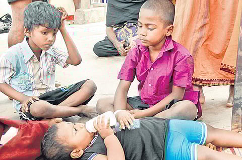 A little Manikandan drinking milk in the presence of two other Manikandans at Lower Thirumuttom in Sabarimala temple | Shaji Vettipuram