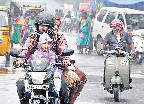 Motorists going to their destination on a rainy Sunday in Vijayawada | R V K Rao