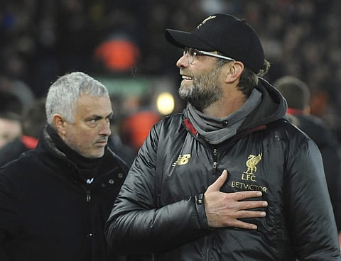 Liverpool manager Juergen Klopp, right, and Manchester United manager Jose Mourinho seen prior to the English Premier League soccer match between Liverpool and Manchester United at Anfield in Liverpool, England, Sunday, Dec. 16, 2018. | AP