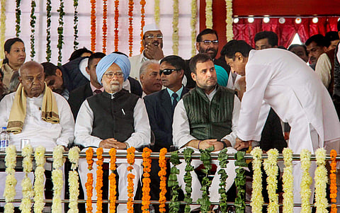 Newly sworn-in Madhya Pradesh Chief Minister Kamal Nath speaks with Congress President Rahul Gandhi as former prime ministers HD Devegowda and Manmohan Singh look on during Nath's swearing-in-ceremony in Bhopal Monday Dec. 17 2018. | PTI